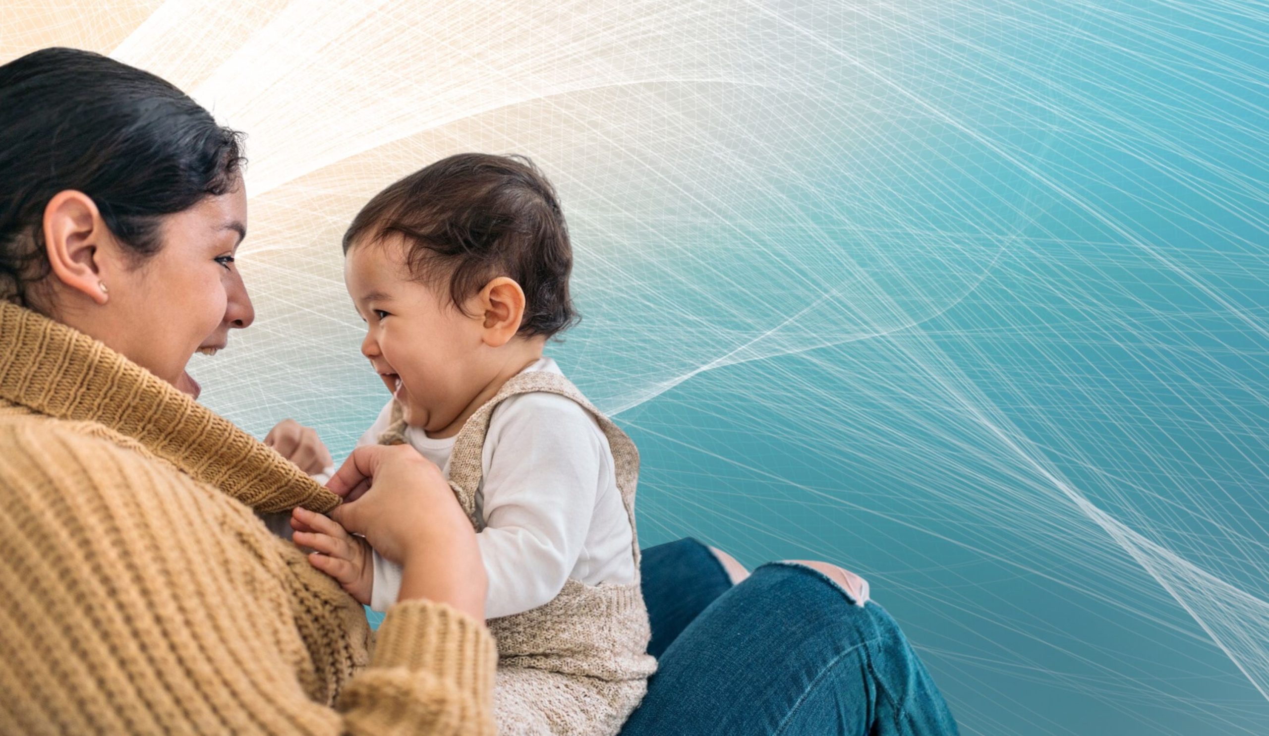 A baby sits with a mother who looks lovingly into their eyes