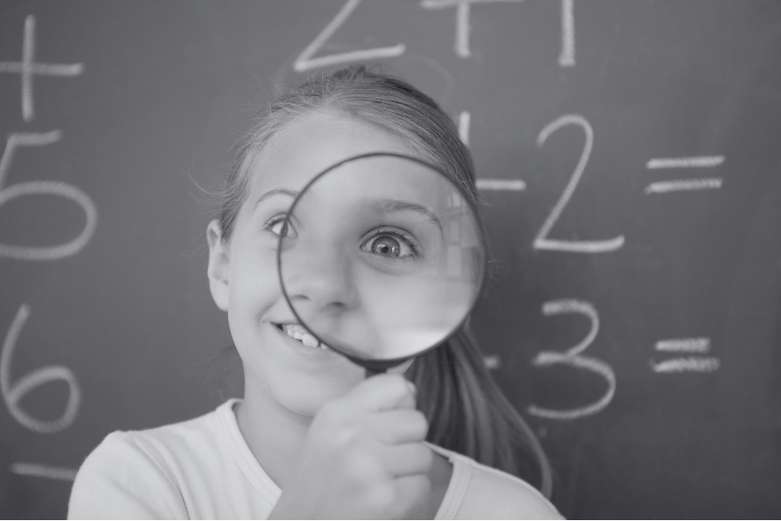 black and white image of girl with magnifying glass